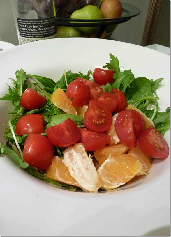 Fresh salad of cherry tomatoes, orange and rocket leaves
