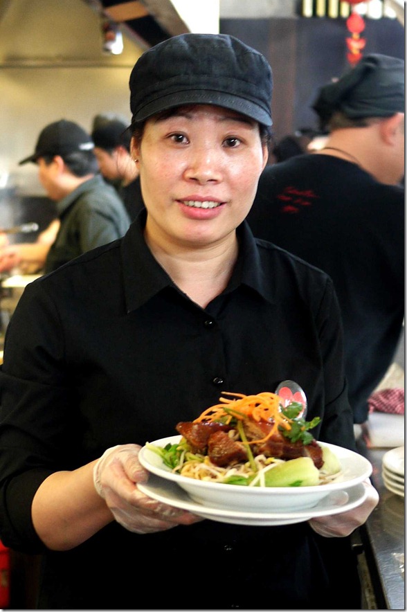 Kelly from the Temple's kitchen with Kon loh hokkien noodles and roast duck