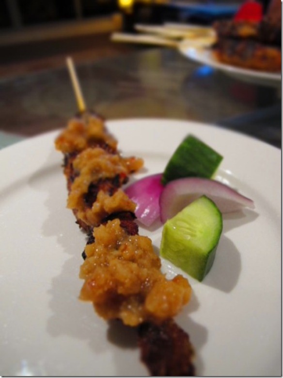 Char-grilled chicken satay ladened with chunky peanut sauce, cucumber and Spanish onions