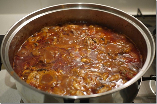 Add cooked oxtail to sauce and simmer until meat is soft and yielding