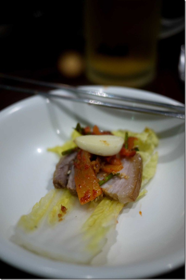 Bossam kimchi - pork belly, kimchi and cooked wombok wrap