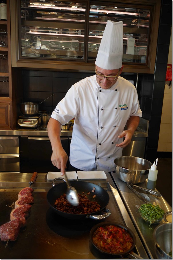 Chef Carlos Pancorbo seasoning meat with sauteeing kidney beans
