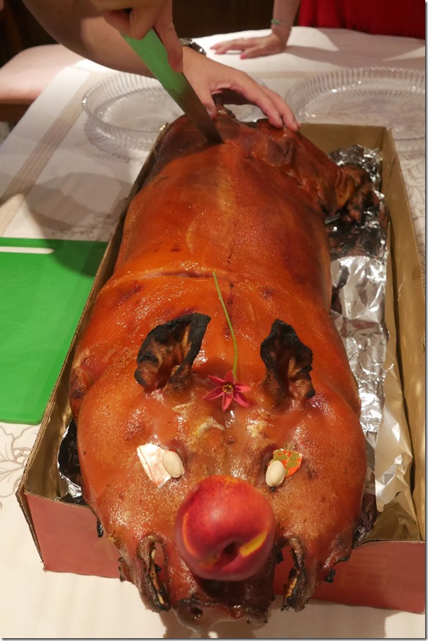 Whole suckling pig being carved